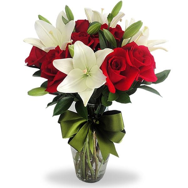 Florero con lilys y 12 rosas rojas, de Florería Isis
